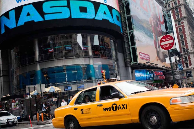 A taxi passes the Nasdaq MarketSite in New York, U.S., on Wednesday, July 13, 2011. Nasdaq OMX Group Inc. has renewed its interest in taking over the London Stock Exchange Group Plc, the Times reported earlier this month, without saying where it got the information. (Paul Taggart/Bloomberg)