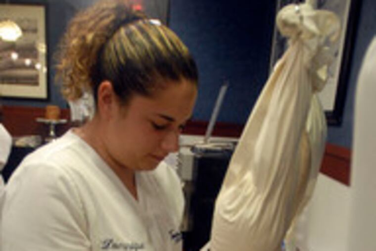 Dominique Frio fills a cannoli at Termini's in the subterranean Market at Comcast Center.
