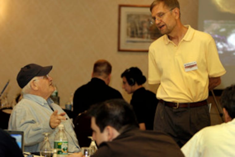 Before the conference , guest speaker Wes Junker (right), an expert on precipitation forecasting, chatted with Karl Leiker,a professor at Westfield State College in Massachusetts.