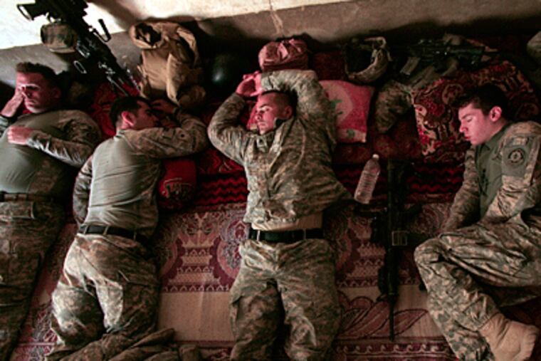 U.S. Army soldiers from Ghostrider Company, Third Squadron, Second Stryker Cavalry Regiment rest, during the midday heat as they occupy a house about 75 miles northeast of Baghdad on Monday. (AP Photo / Maya Alleruzzo)
