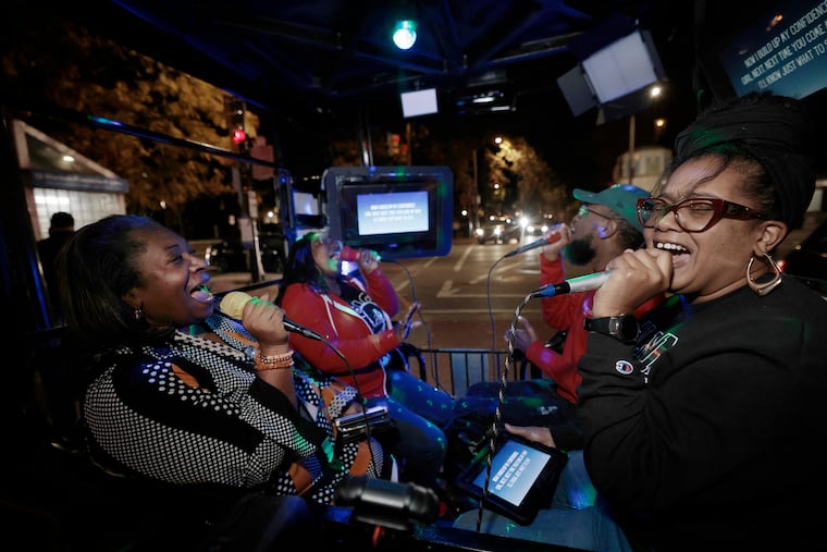 Alicia Estrada (from left), Brittany Reid-Harden, Kairi Creighton, and Lindsey Perkins of Philadelphia sing “Can We Talk” by Tevin Campbell while riding in the FunCab in Philadelphia. Center City residents are split on the new mobile karaoke experience.