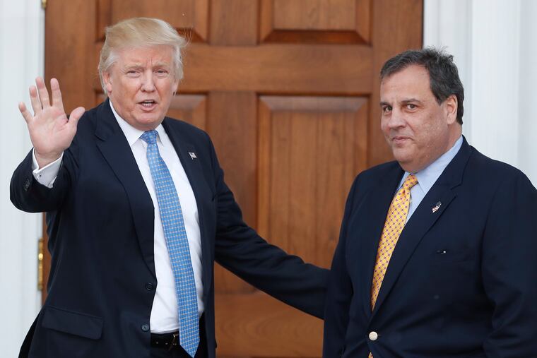 Then President-elect Donald Trump, left, waves to the media as New Jersey Gov. Chris Christie arrives at the Trump National Golf Club Bedminster clubhouse, in Bedminster, N.J. in 2016.
