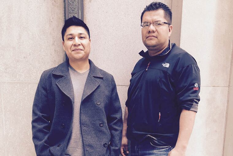 Victim advocate Esteban Calel (left) helped Jesus Garcia, who was injured in an attack. Now Garcia is returning the kindness, helping to host a benefit for Victim/Witness Services of South Philadelphia. (HELEN UBIÑAS / DAILY NEWS STAFF)