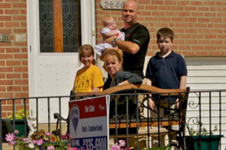 Micki Rice and her family may be headed for suburbia because of the uncertain financial status of city schools. She is accompanied by her family (from left) Starr, 10; Derrick, 12; and husband Bill Rice holding daughter Katerina.