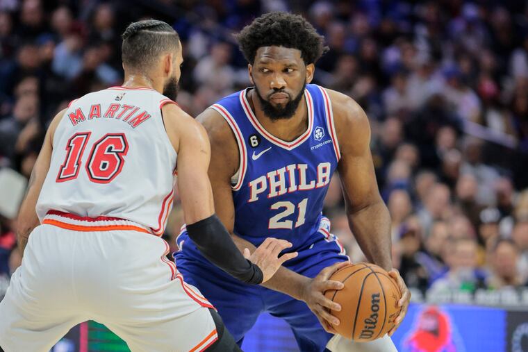 Sixers Joel Embiid drives on the Heat’s Caleb Martin during the 2nd quarter at the Wells Fargo Center in Philadelphia, Monday, February 27, 2023.