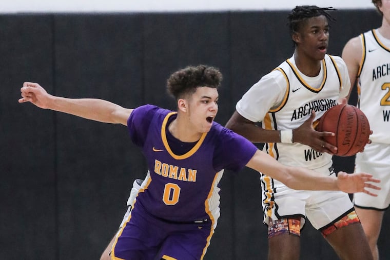 Roman Catholic Daniel Skillings, 0, tries to take the ball from Archbishop Wood Bahsil Laster 4, during the 4th quarter in Warminster, Wednesday, January 12, 2022. Wood beats Roman 64-61