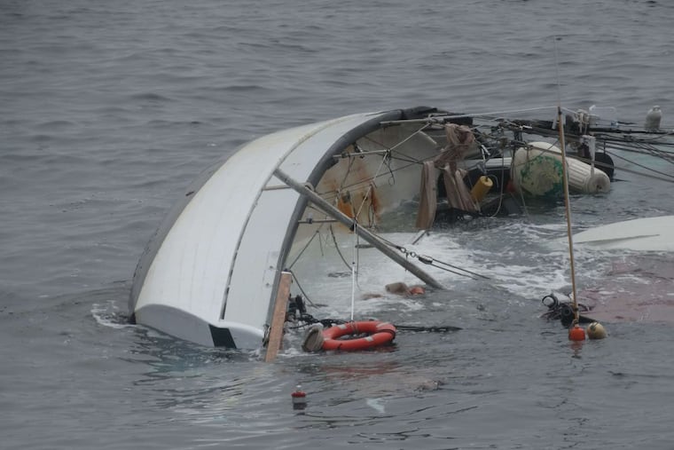 The Coast Guard rescued a man and woman who clung to the hull of this sailboat for about three hours after it capsized 65 miles off Atlantic City in rough weather Wednesday night.