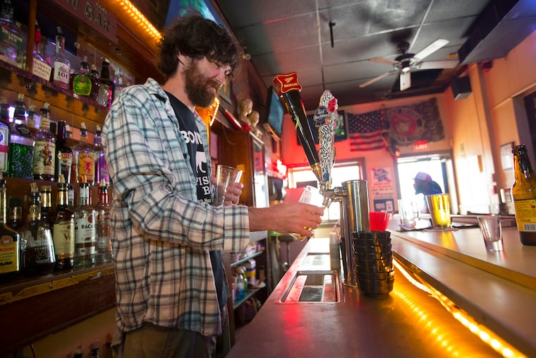 At Bonnie's Capistrano bar, bartender Eamon Gallagher pour a beer.