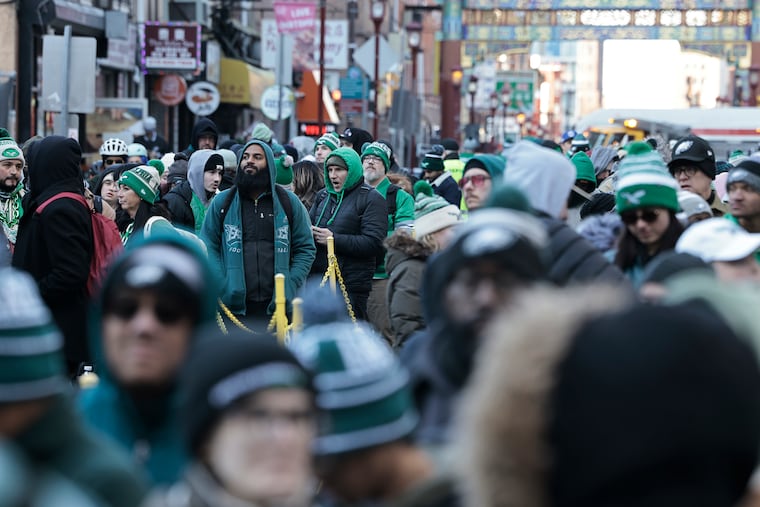 Eagles fans wait in long lines on 10th Street, to get into SEPTA’s Jefferson Station after the Super Bowl LIX victory parade Friday Feb. 14, 2025.