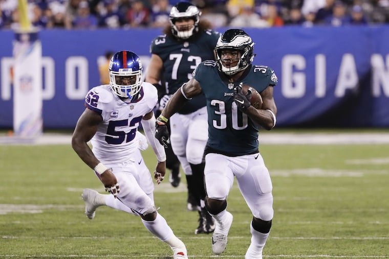 Eagles running back Corey Clement runs past New York Giants linebacker Alec Ogletree during the third quarter on Thursday.