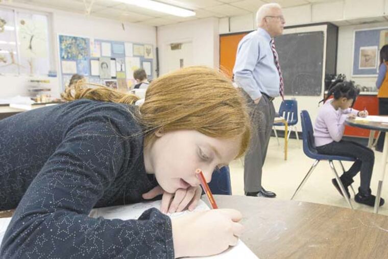 Second grader Julianna Banfe, 9, draws in art class. In background is Headmaster William C. Probsting at Westfield Friends School, Cinnaminson, February 5, 2013. ( DAVID M WARREN / Staff Photographer )