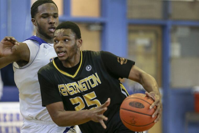 Kensington's LaQuan Drago drives on George Washington's James Ramsey during Monday afternoon's Public League basketball game at George Washington. Drago scored 12 as Kensington won, 69-61.