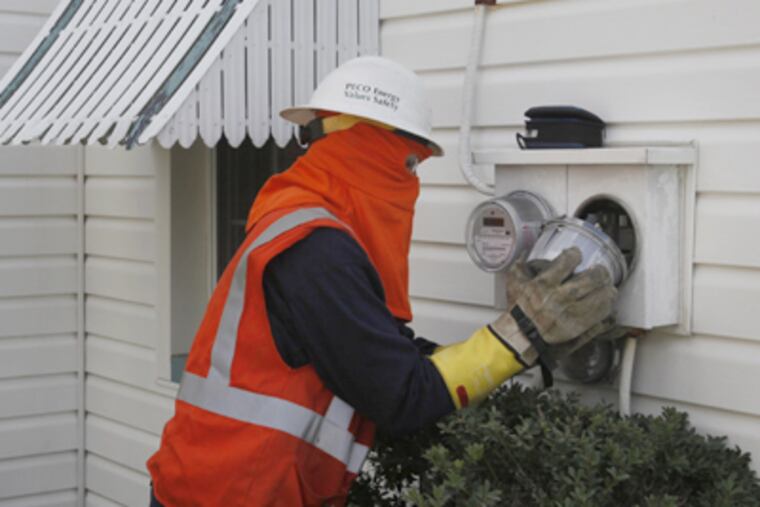 Wearing a fireproof suit, Peco field technician Steven Carbonara installs a smart meter in Bristol, Bucks County. (Michael S. Wirtz / Staff Photographer)