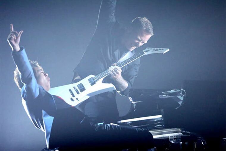Classic rock: Concert pianist Lang Lang with Metallica guitarist James Hetfield, performing the heavy-metal band's song "One" at the Grammy Awards last Sunday. (Matt Sayles/Invision)