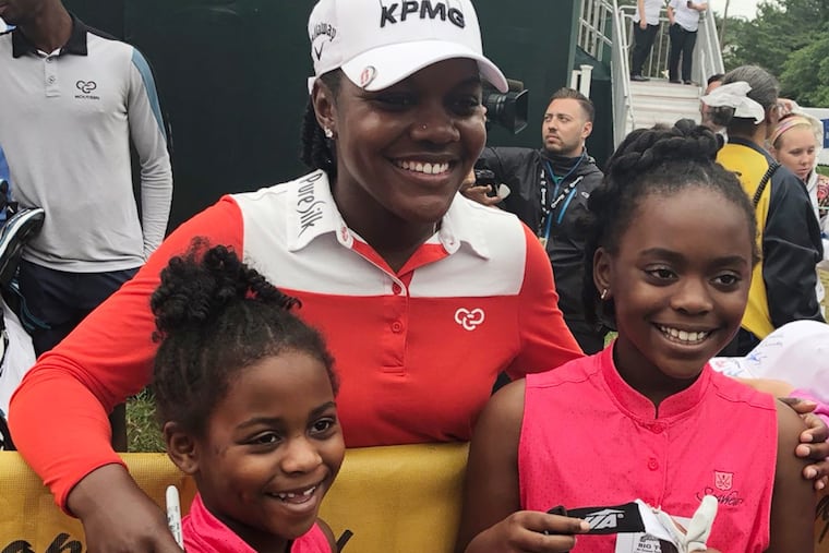 Golfer Mariah Stackhouse poses with Brianna Wright, 7, and Callie Wright, 9, of Blue Bell, Pa., after the final round of the ShopRite LPGA Classic.