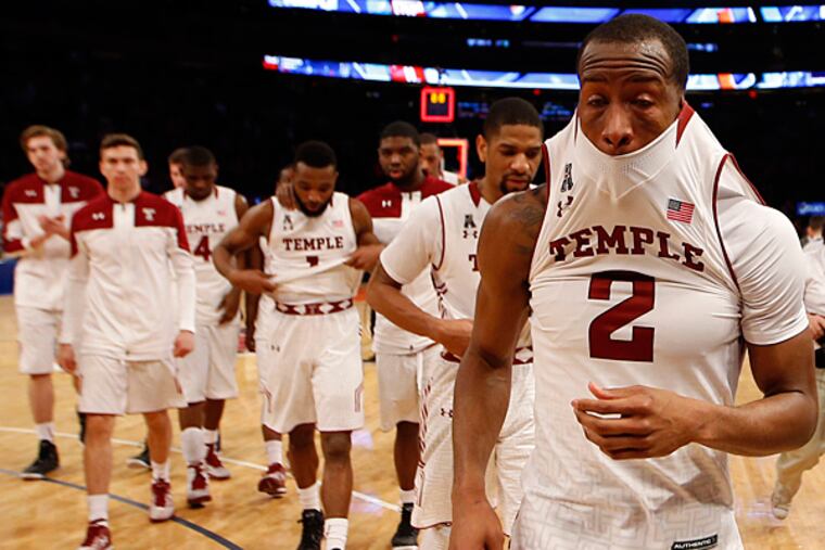 Temple's Will Cummings walks off the court with his teammates after
losing to Miami in the NIT semifinal game. (Yong Kim/Staff Photographer)