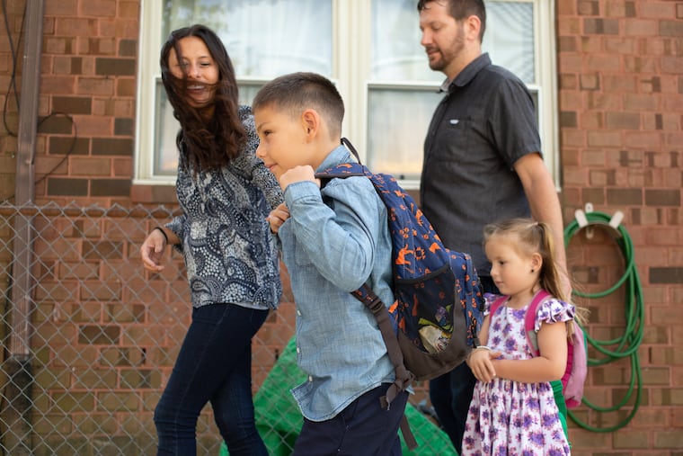 Ari Taffet, 6, walks with a bullet proof insert in his backpack alongside his sister, Now, 3, his mom, Natasha, and his dad, Omer, in the Point Breeze neighborhood, South Philadelphia, Tuesday, August 25, 2019. The Taffets bought a bulletproof insert for less than $100 and slid it into what looks like a laptop pouch in his backpack.