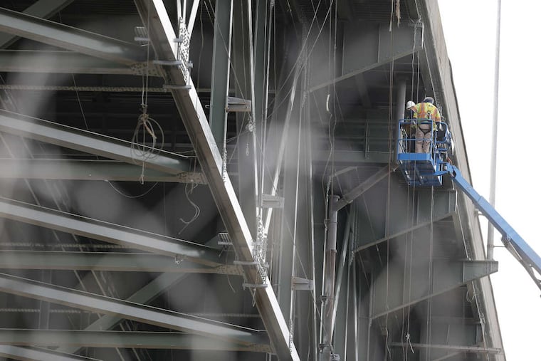 Workers inspect the area where a crack was found on the PA/NJ Turnpike connector bridge in Bristol in January.