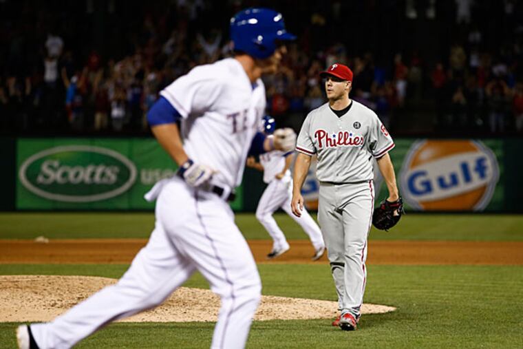Jonathan Papelbon, right, leaves the field after walking in Texas Rangers' Jim Adduci, left, during the ninth inning of a baseball game on Wednesday, April 2, 2014, in Arlington, Texas. The Rangers won 4-3. (Jim Cowsert/AP)