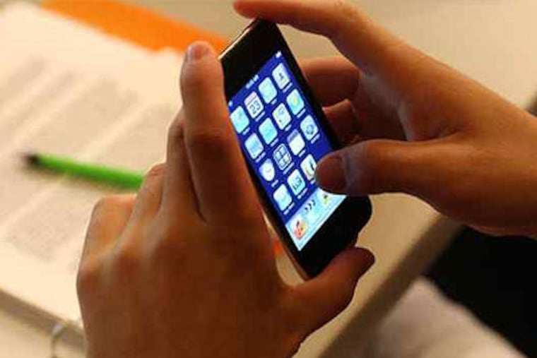 A Central Michigan University student uses an iPod touch to answer a professor's question. Now, a group of brain surgeons plans to follow the example during their May convention in Philly. (AP Photo)