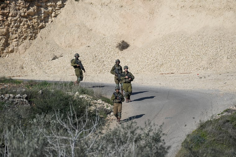 Israeli soldiers patrol the scene after a Palestinian was shot and killed following an alleged attempted attack on an Israeli, next to Sde Efraim farm in the West Bank, Saturday, Jan. 21, 2023.