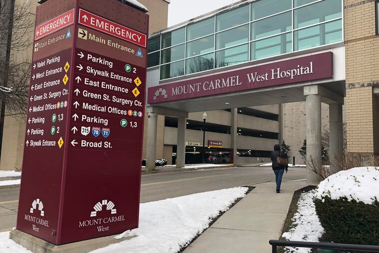 The main entrance to Mount Carmel West Hospital is shown Tuesday, Jan. 15, 2019. An intensive care doctor ordered "significantly excessive and potentially fatal" doses of pain medicine for over two dozen near-death patients in the past few years after families asked that lifesaving measures be stopped, an Ohio hospital system announced after being sued by a family alleging a dose of fentanyl hastened a woman's death. The Columbus-area Mount Carmel Health System said it fired the doctor, reported its findings to authorities and removed multiple employees from patient care pending further investigation, including nurses who administered the medication and pharmacists. (AP Photo/Andrew Welsh Huggins)