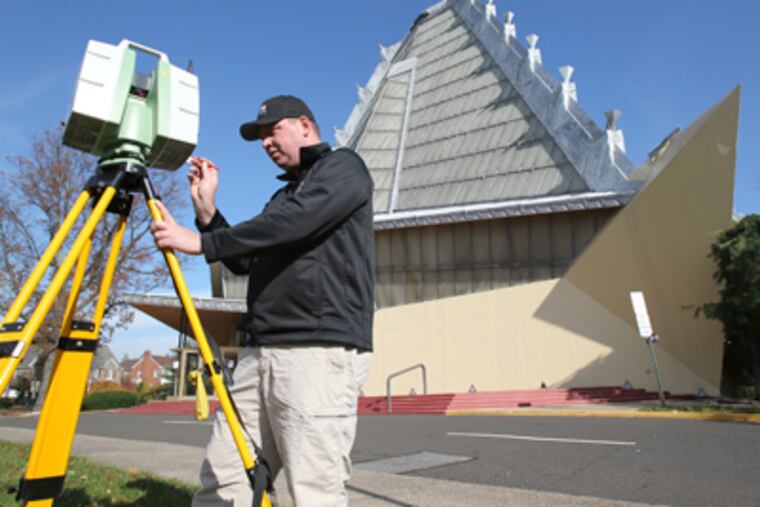 Pete Aiston of DJS Associates sets up a digital scanning device at the Frank Lloyd Wright-designed Beth Sholom synagogue in Elkins Park. (Charles Fox / Staff Photographer)