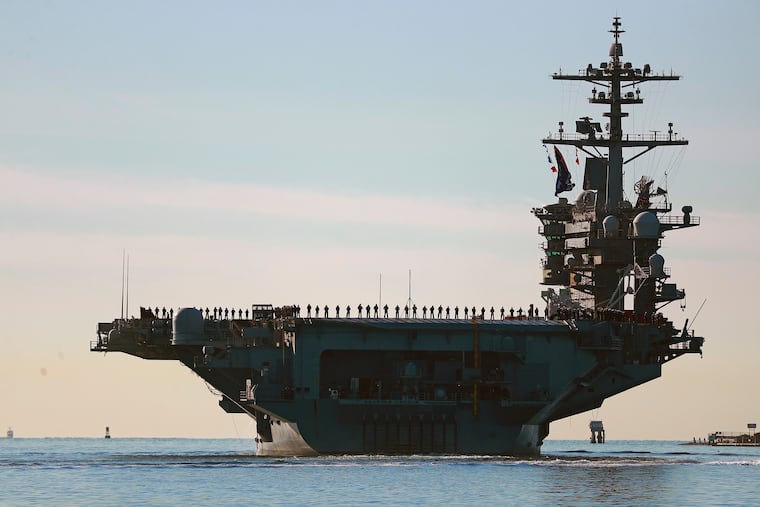 Sailors and marines line the deck of aircraft carrier USS Abraham Lincoln (CVN-72) as it deploys from San Diego,, Jan. 3, 2021. The ship has been deployed in support of the Iran war for an uninterrupted 240 days.