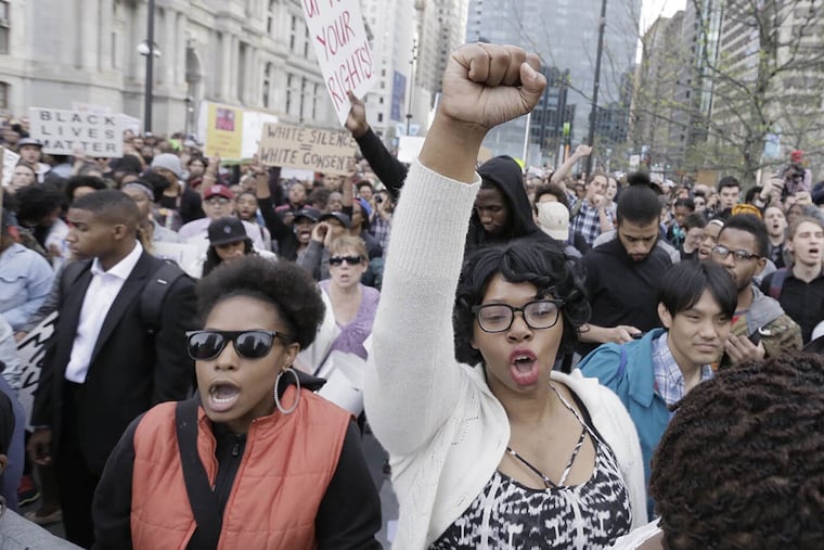 Protesters assembled at City Hall demanding that police abuse end. (ELIZABETH ROBERTSON / Staff Photographer)