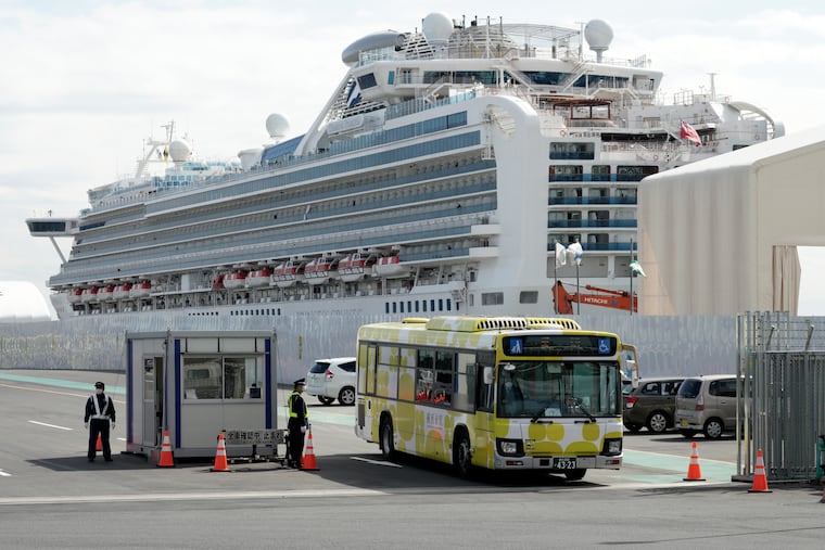 A bus carrying the passengers from the quarantined Diamond Princess cruise ship leaves a port in Yokohama, near Tokyo, Wednesday, Feb. 19, 2020. Passengers tested negative for COVID-19 started disembarking Wednesday.
