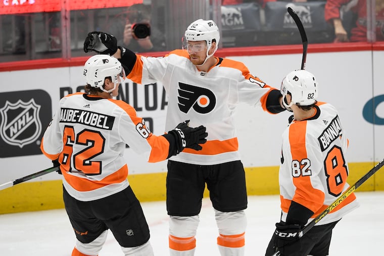 Flyers left wing Michael Raffl (center) celebrates his goal with right wing Nicolas Aube-Kubel (62) and center Connor Bunnaman (82) during the second period.