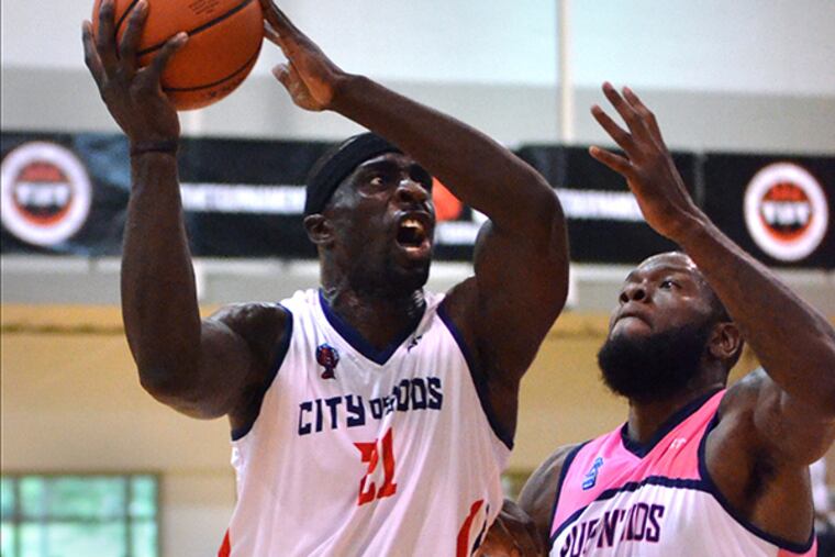 City of Gods Pops Mensah Bonsu ,21, puts up a shot driving past Team Pup 'N Suds defenders during their contest in The Basketball Tournament at Philadelphia University on Friday. July 17, 2015.