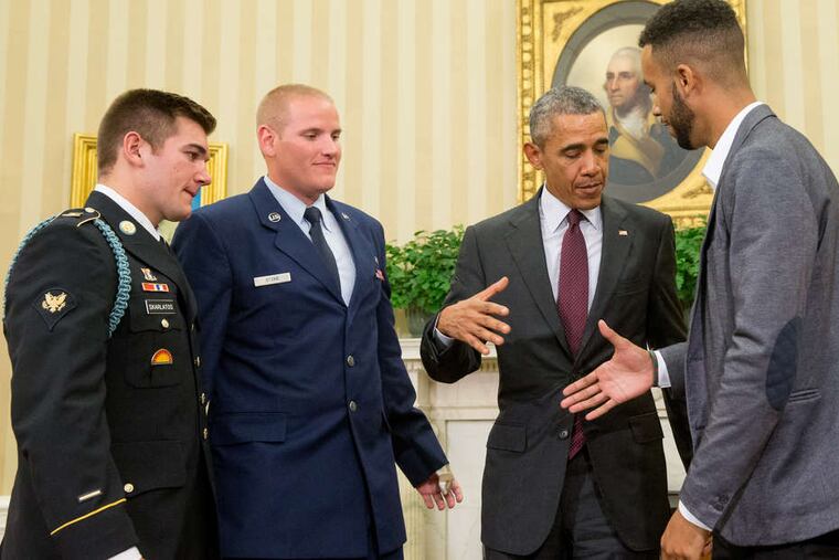 President Obama prepares to shake hands with Anthony Sadler while honoring him, National Guardsman Alek Skarlatos, and Airman First Class Spencer Stone in the Oval Office.