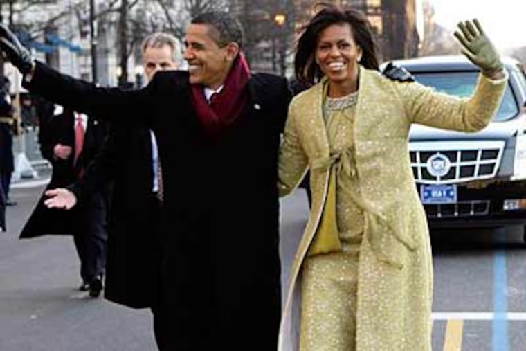 President Barack Obama and first lady Michelle Obama walk down Pennsylvania Avenue en route to the White House, Tuesday, Jan. 20, 2009, Washington. (AP Photo/Doug Mills, Pool)