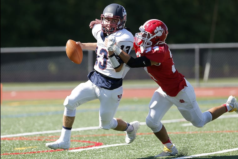 Andrew Heck (left) will compete at the quarterback spot again this season. Here, he is pursued last season by Cherry Hill East's Sean Coen.