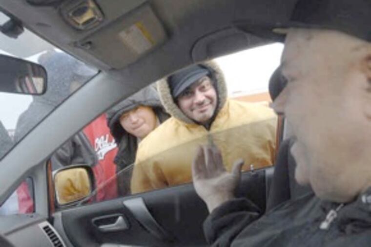 Day laborers, mostly immigrants, outside the Home Depot in Crescentville. The workers, many undocumented, jostle for a modest day's pay from contractors and homeowners. (April Saul / Staff Photographer)