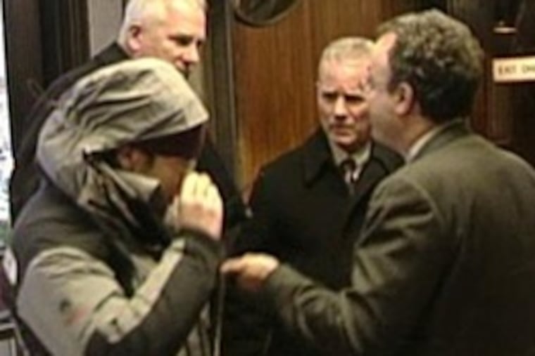 Jocelyn Kirsch, 22, hides in a parka as she turns herself in. Photos of Kirsch have circulated widely since her arrest.