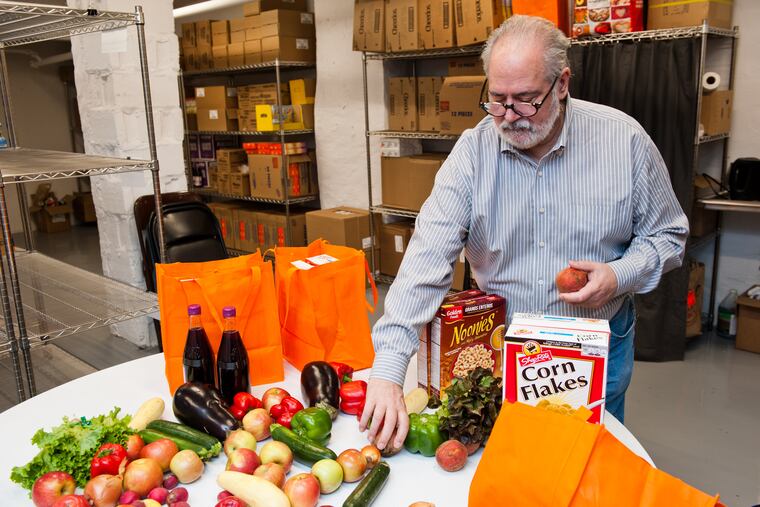 A volunteer prepares a food order at a Jewish Federation of Greater Philadelphia Mitzvah Food Pantry in Bala Cynwyd.