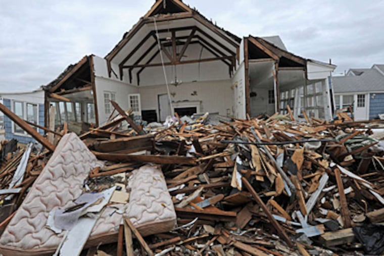 The wreckage of a house opened wide by Sandy sits on the bay in Mantoloking.