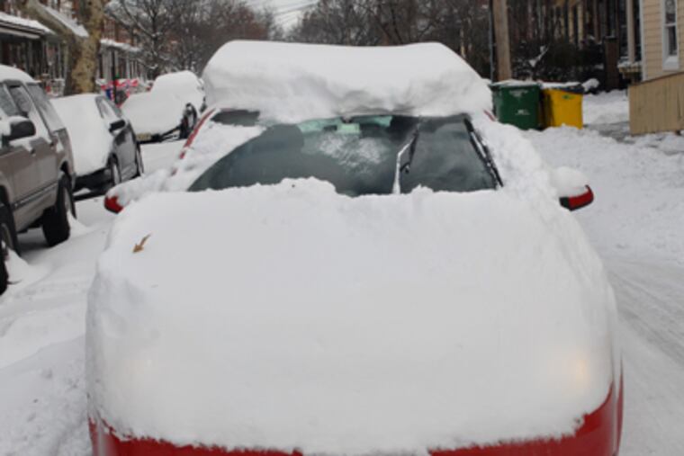 Barely bothering to clear the snow from his car, a driver is stopped at the traffic light on Collins Avenue at Haddon Avenue in Collingswood, Monday morning. (Tom Gralish / Staff Photographer)