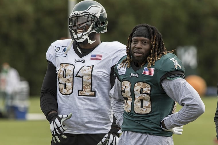 Eagles all-pro defensive tackle Fletcher Cox (left) with newly acquired running back Jay Ajayi at practice.