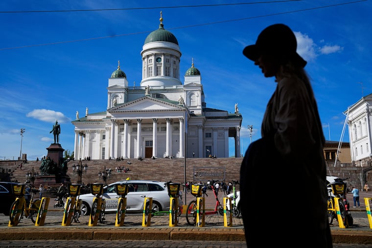 FILE - A woman walks past the Helsinki Cathedral in Helsinki, May 29, 2023. (AP Photo/Pavel Golovkin, File)