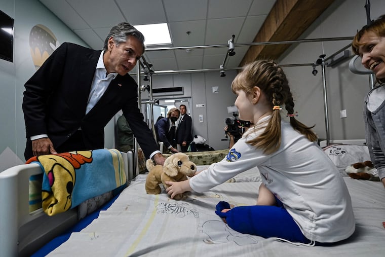 Secretary of State Antony Blinken gives a gift to Marina, 6, from the Kherson region, during a visit to a children's hospital in Kyiv, Ukraine on Thursday.