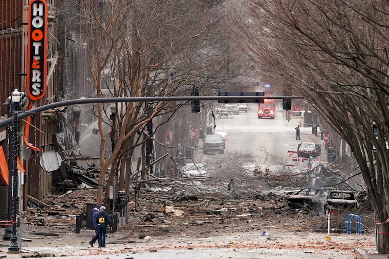 Emergency personnel work near the scene of an explosion in downtown Nashville, Tenn., Friday, Dec. 25, 2020. Buildings shook in the immediate area and beyond after a loud boom was heard early Christmas morning.