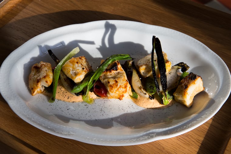 The Abu Sayf grilled halibut kebab at Suraya is dusted with grated black Omani lime.