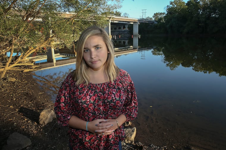 Erin McCarthy stands on the banks of the Schuylkill River near Valley Forge, much closer to home than the Bradford County section of the Susquehanna River where she was trapped for 20 minutes in rushing water this summer.