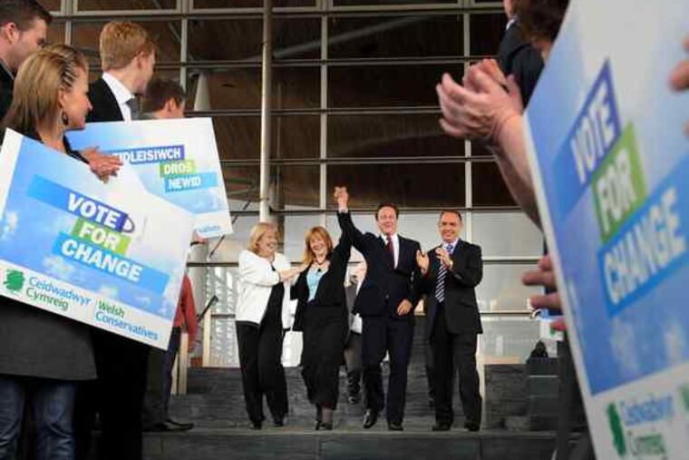 Conservatives David Cameron (center right) , the party leader , and Kay Swinburne (center left), a member of European Parliament from Wales, acknowledge supporters yesterday.