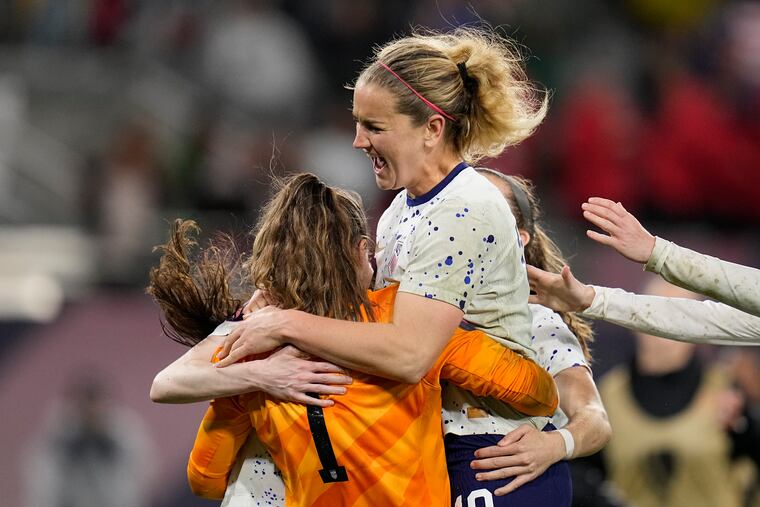 U.S. captain Lindsey Horan (center) leaps into the arms of goalkeeper Alyssa Naeher after Naeher's heroics in the penalty kick shootout.