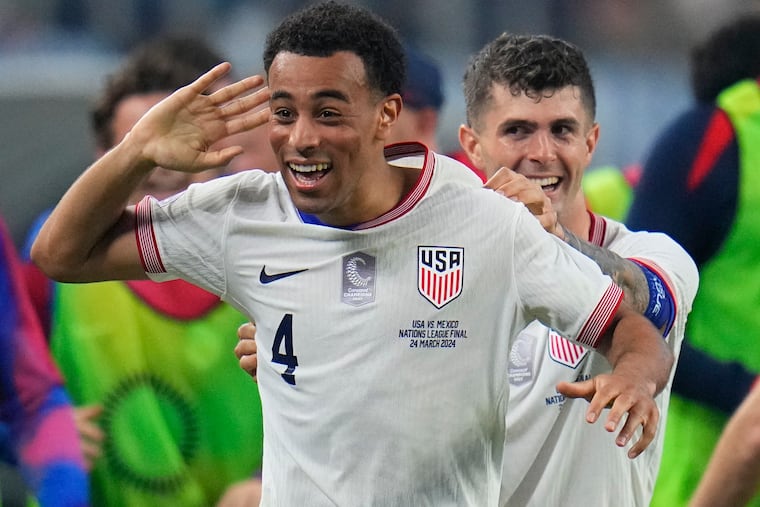 U.S. midfielder Tyler Adams (4) celebrates his goal with Christian Pulisic.