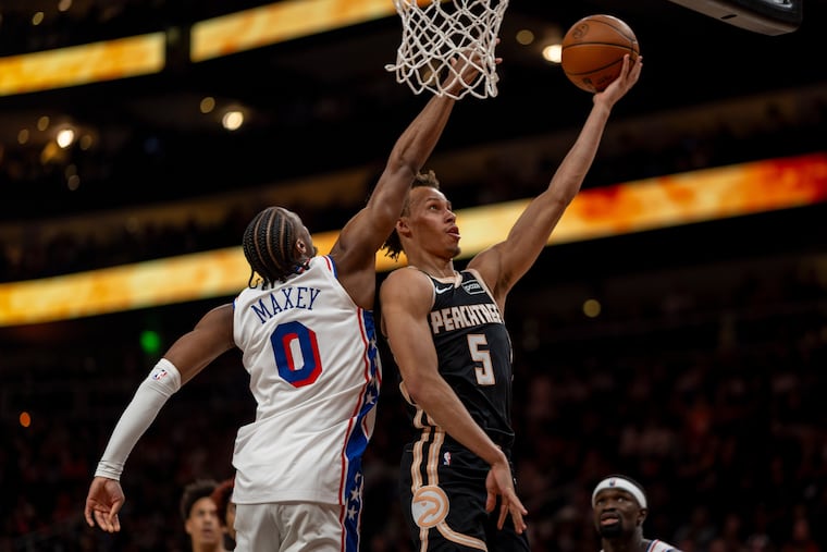 Atlanta Hawks guard Dyson Daniels (5) makes a basket against Philadelphia 76ers guard Tyrese Maxey xg (0) during the first half of an NBA basketball game, Saturday, March 7, 2026, in Atlanta. (AP Photo/Erik Rank)